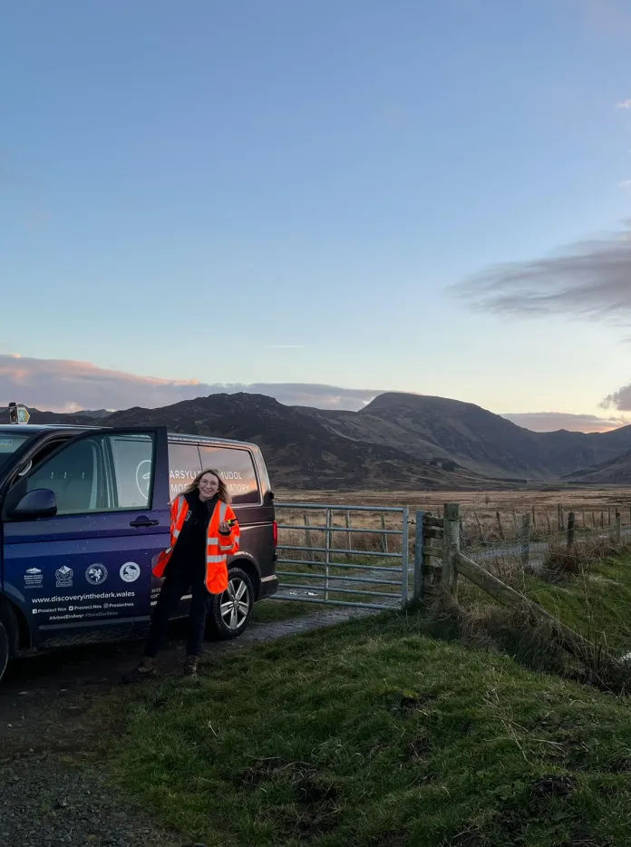 Dani standing next to her campervan