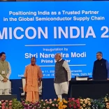 Men on stage in front of large screen