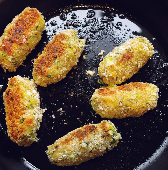 Glamorgan sausages frying in a pan