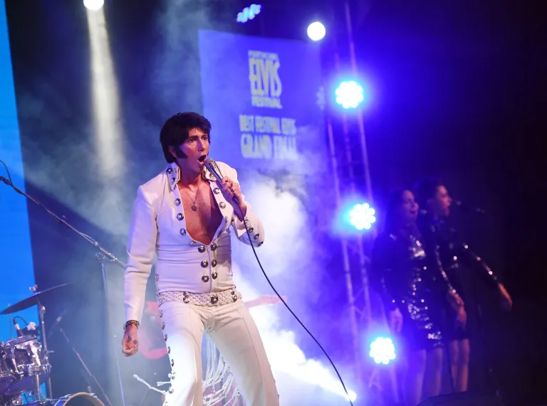 An Elvis tribute act singing into a microphone