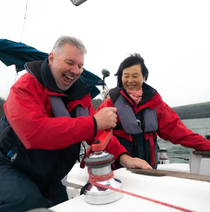 Two people sailing off the coast of Tenby, West Wales.