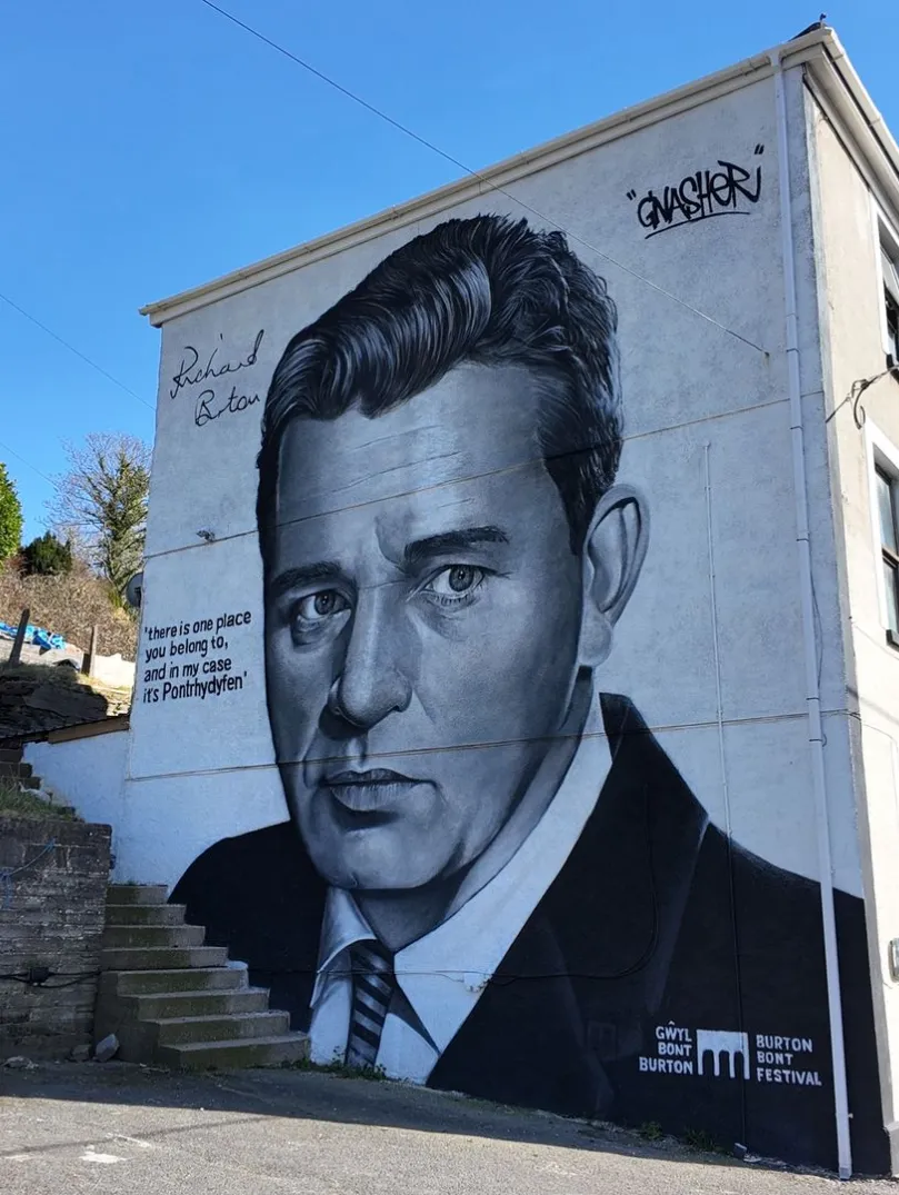 A painting of Richard Burton on the side of a building