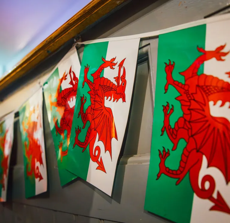 Welsh flags hanging on a wall.