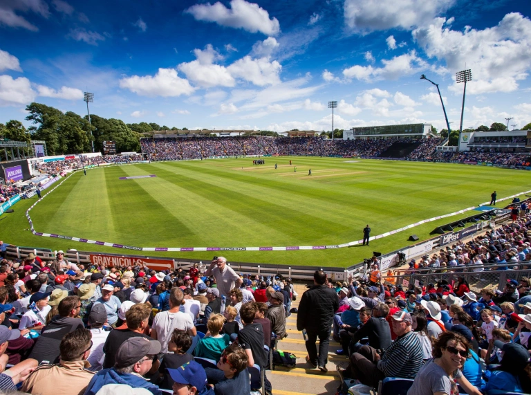 A crowd of people watching the cricket