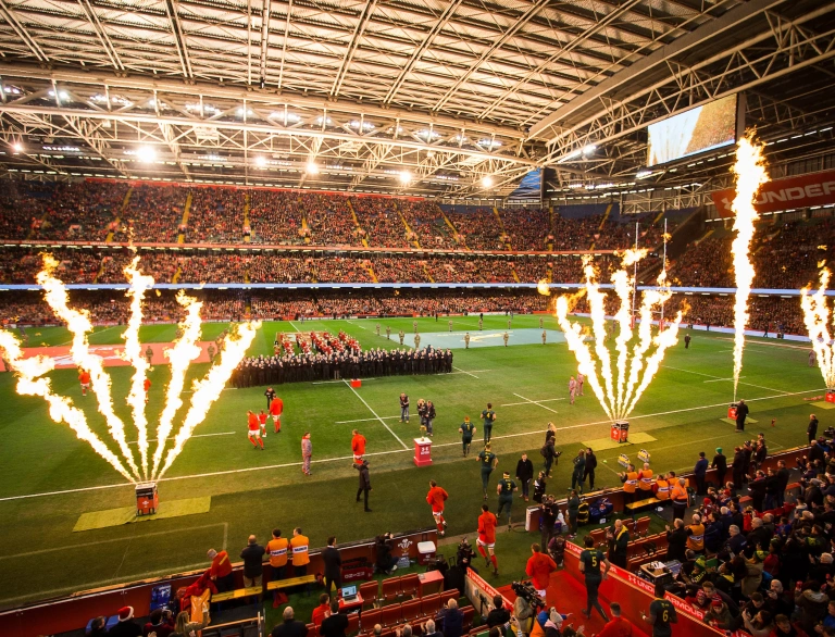 Two rugby teams walking onto a pitch for a match 
