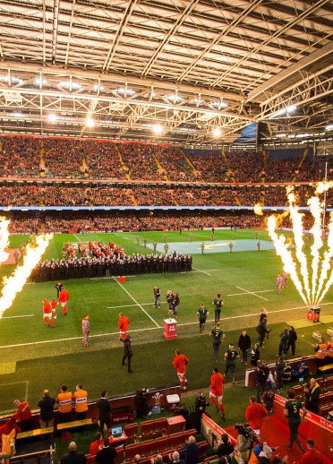 Two rugby teams walking onto a pitch for a match 