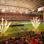 Two rugby teams walking onto a pitch for a match 