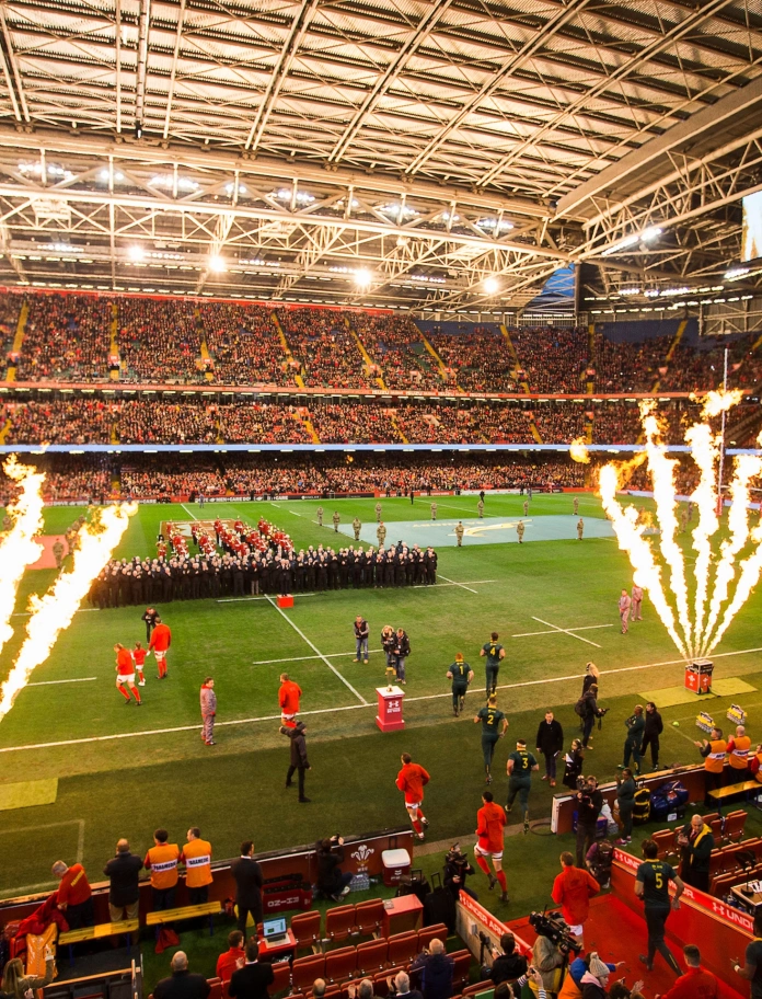Two rugby teams walking onto a pitch for a match 