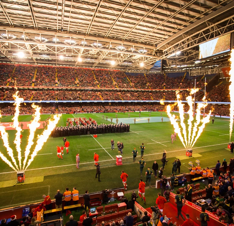 Two rugby teams walking onto a pitch for a match 