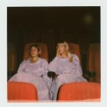 Two people sitting on chairs