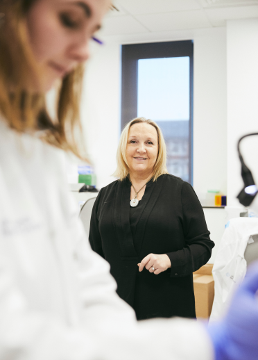 Professor Julie Williams with female scientist, Cardiff University's Hadyn Ellis building