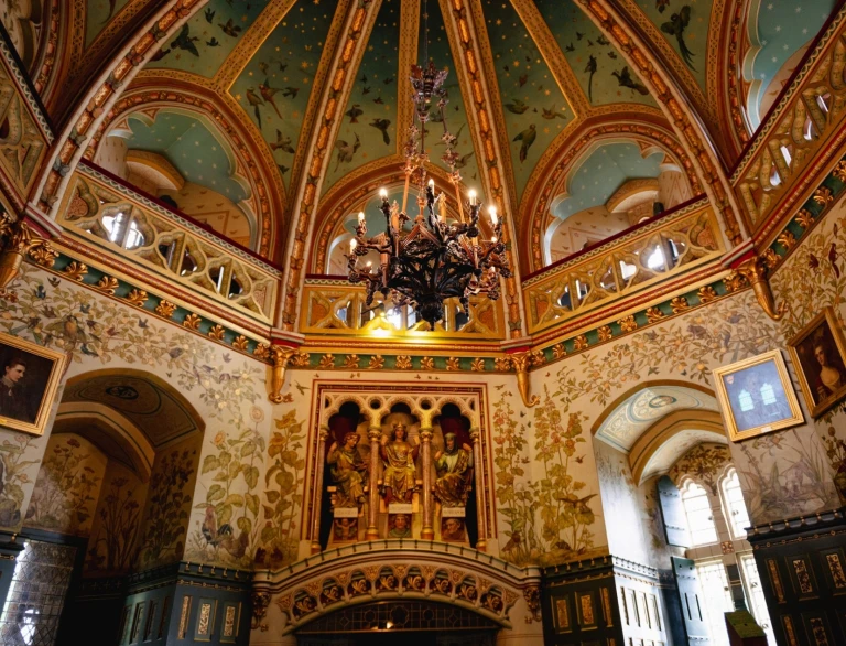 An ornate historical interior of an old castle with a domed ceiling and chandelier