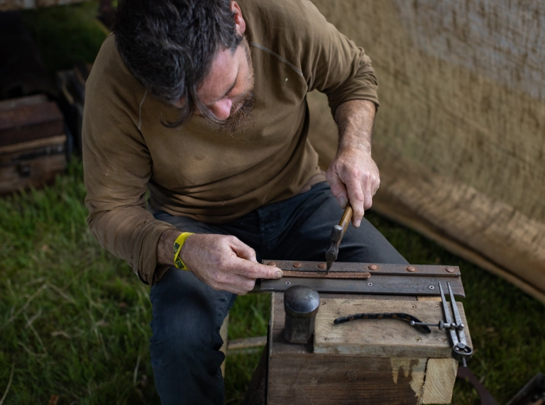 A person working at one of the crafting workshops.