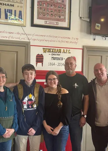 Six people standing and smiling at the camera.