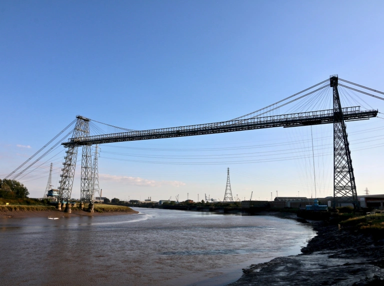 A large industrial transporter bridge spanning a wide river