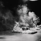 A steaming steak on a board.