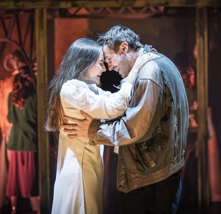 Two actors playing Romeo and Juliet acting on stage