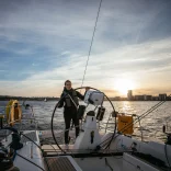 Hannah Mills at the wheel of the yacht, sailing in Cardiff Bay