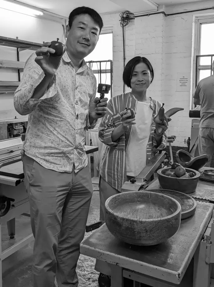 Two people standing in a kitchen