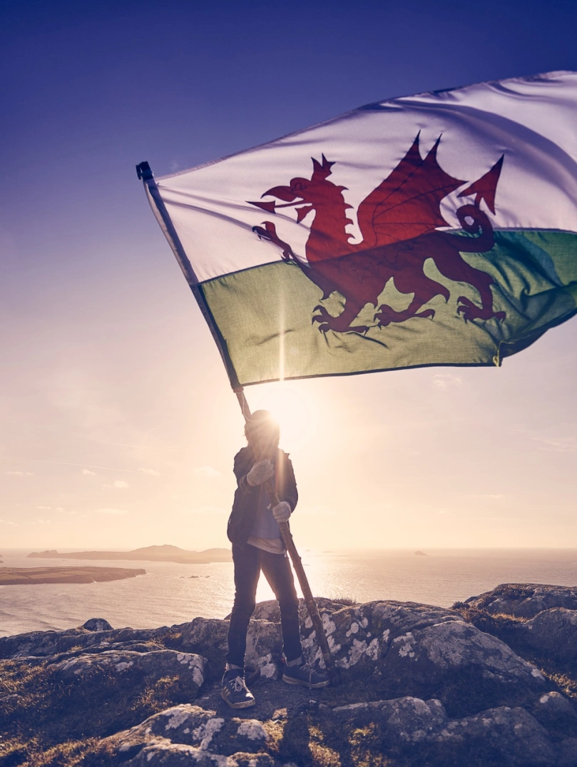 Person holding the Wales flag.