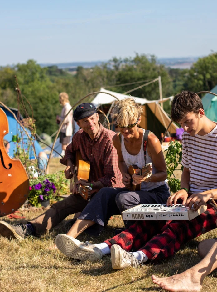 A group of people sat playing instruments.