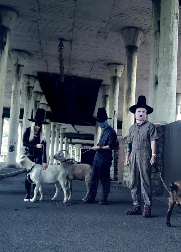 Members of NoGood Boyo standing with dogs.