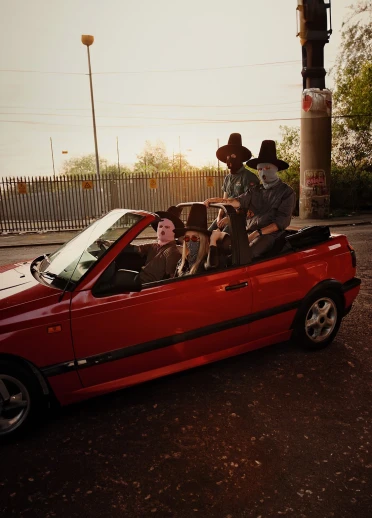 The band NoGood Boyo wearing masks and sitting in a car.