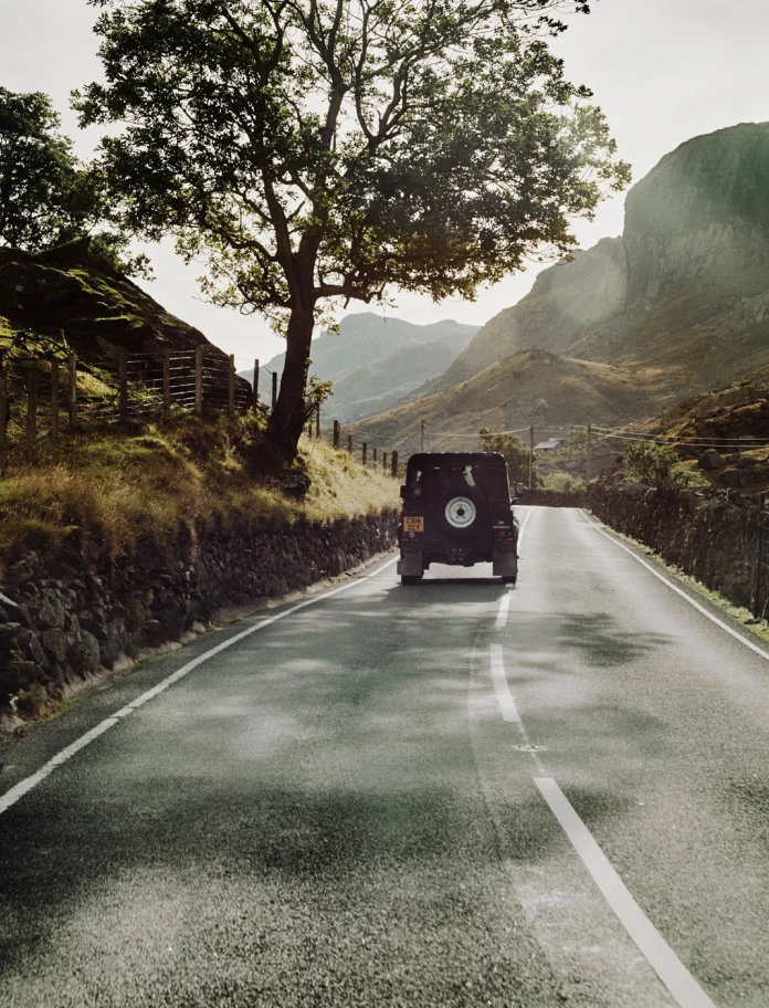 4x4 driving away from camera through Snowdonia
