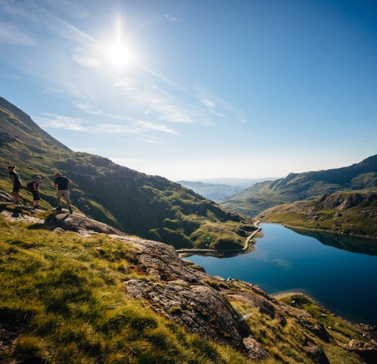 A scenic lake surrounded by large green mountains