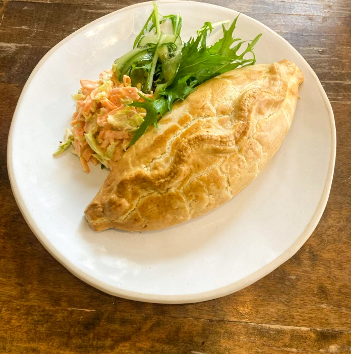 A Welsh oggy (pasty) served on a plate