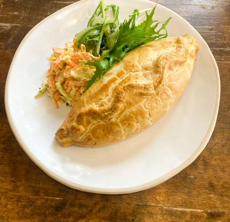 A Welsh oggy (pasty) served on a plate