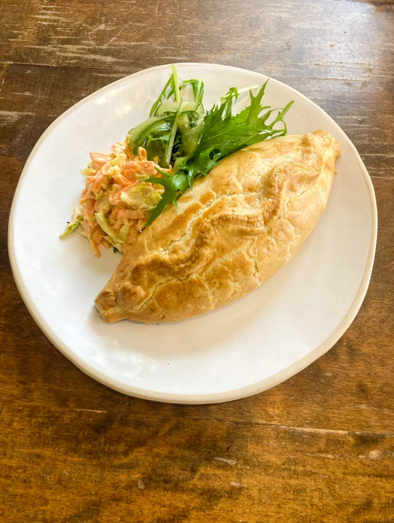 A Welsh oggy (pasty) served on a plate