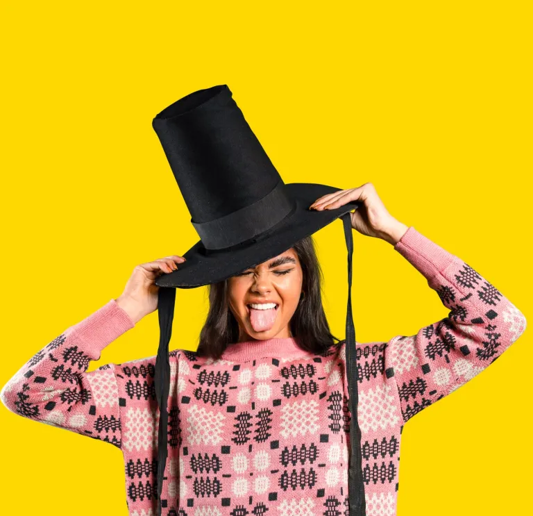 Woman wearing a Welsh hat and sticking her tongue out