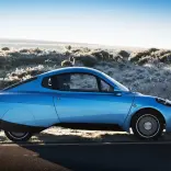 Side view of Riversimple Rasa hydrogen car on desert background