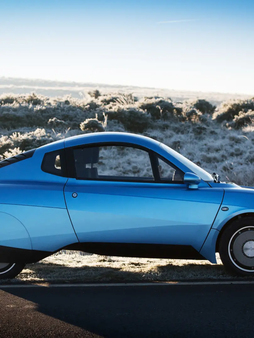 Side view of Riversimple Rasa hydrogen car on desert background