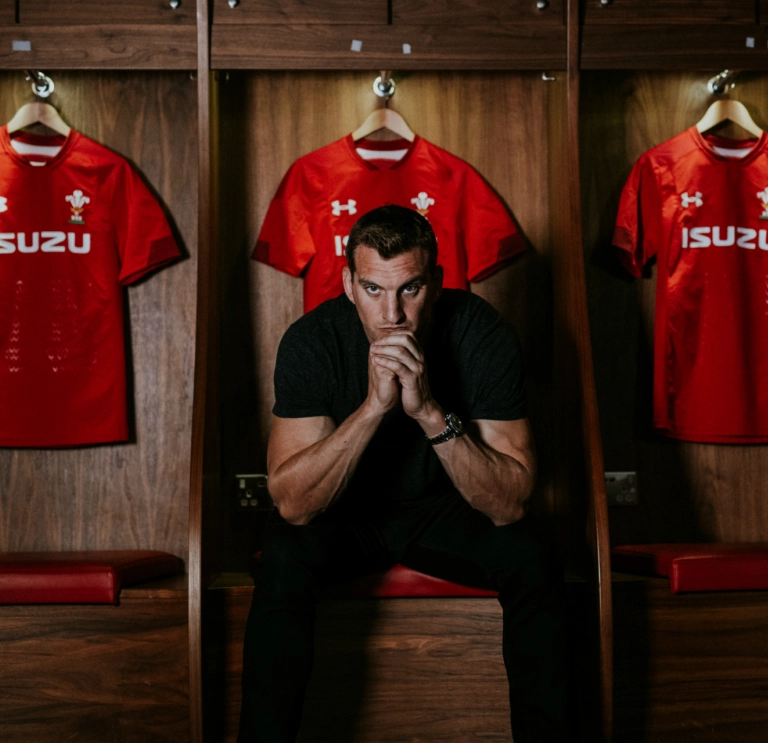 Sam Warburton in the Wales rugby team changing room staring down the lens of the camera.