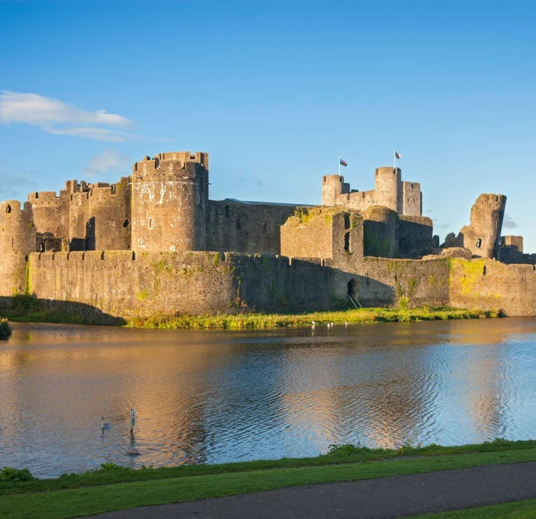 A large castle seen over a moat