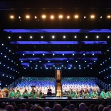 People dressed in costumes standing on stage.