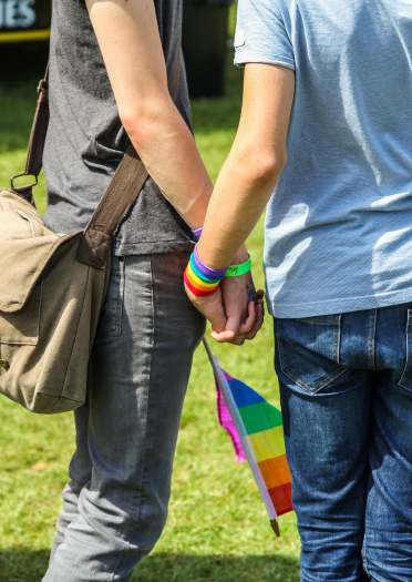 Male couple holding hands at Pride Cymru Festival