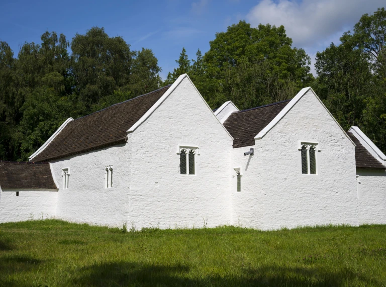 exterior of whitewashed stone church.