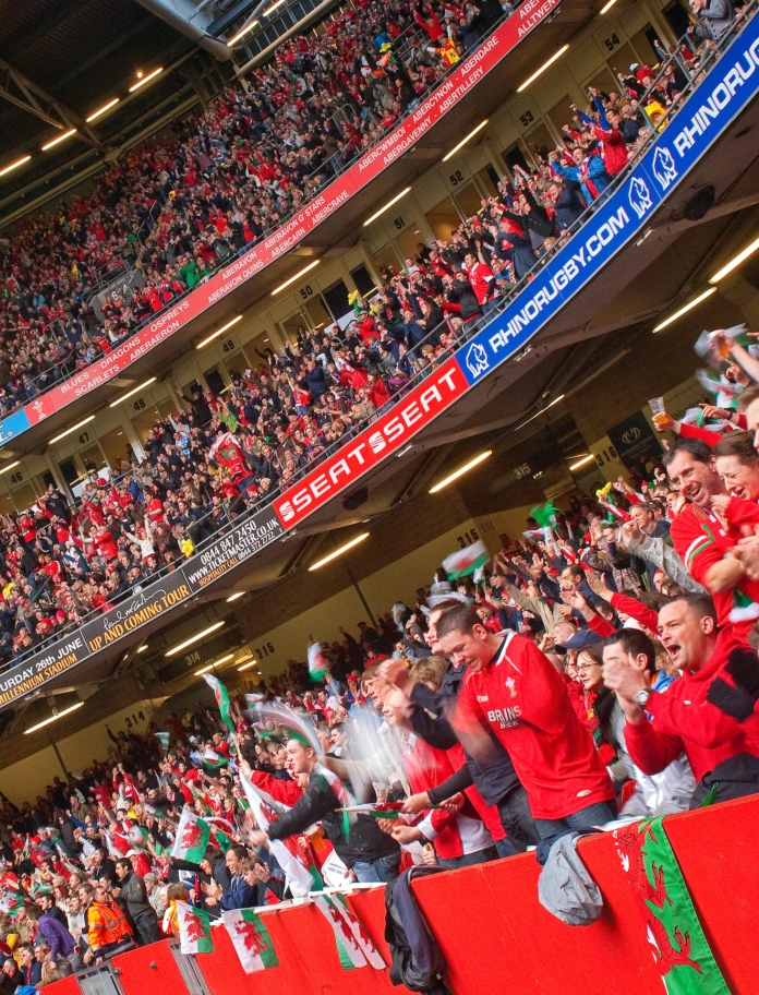 A large crowd of Welsh rugby fans inside a stadium