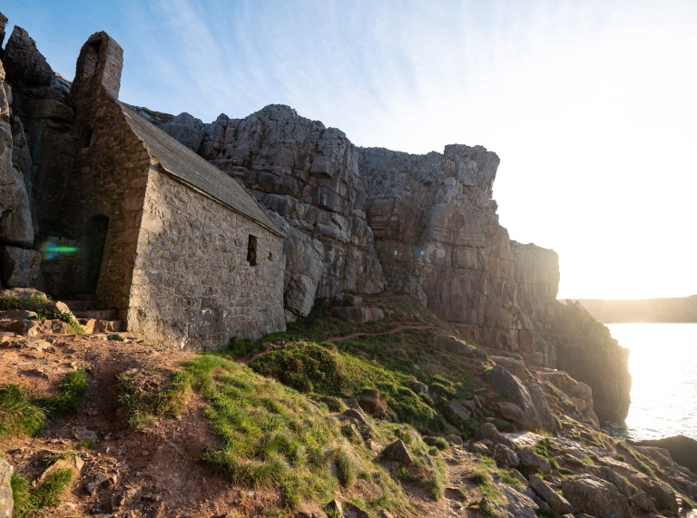 old stone chapel and sea cliff.