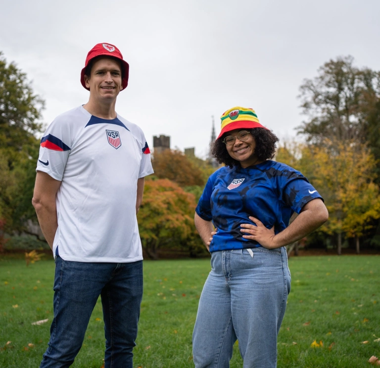 Two people standing and smiling at the camera.