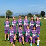 The young Swiss female football team standing on the pitch.