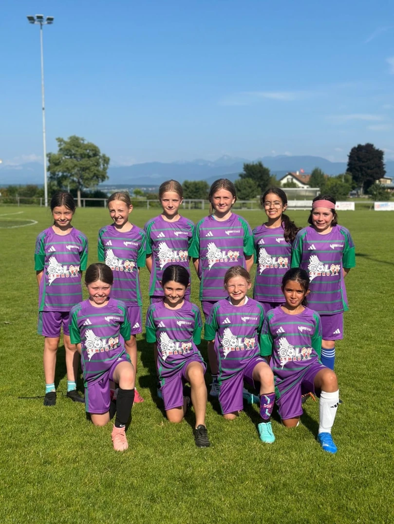 The young Swiss female football team standing on the pitch.