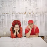 The two members of Rogue Jones sitting with their hands to their face.