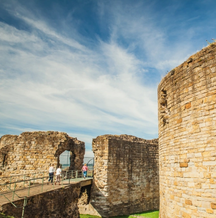 A family exploring the ruins of an old grand castle
