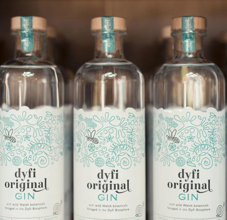 Dyfi original gin bottles lined up on shelf