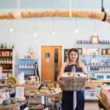 Employee holding hamper in Halen Mon gift shop