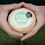 Close-up shot of hands holding Celtic Promise cheese.